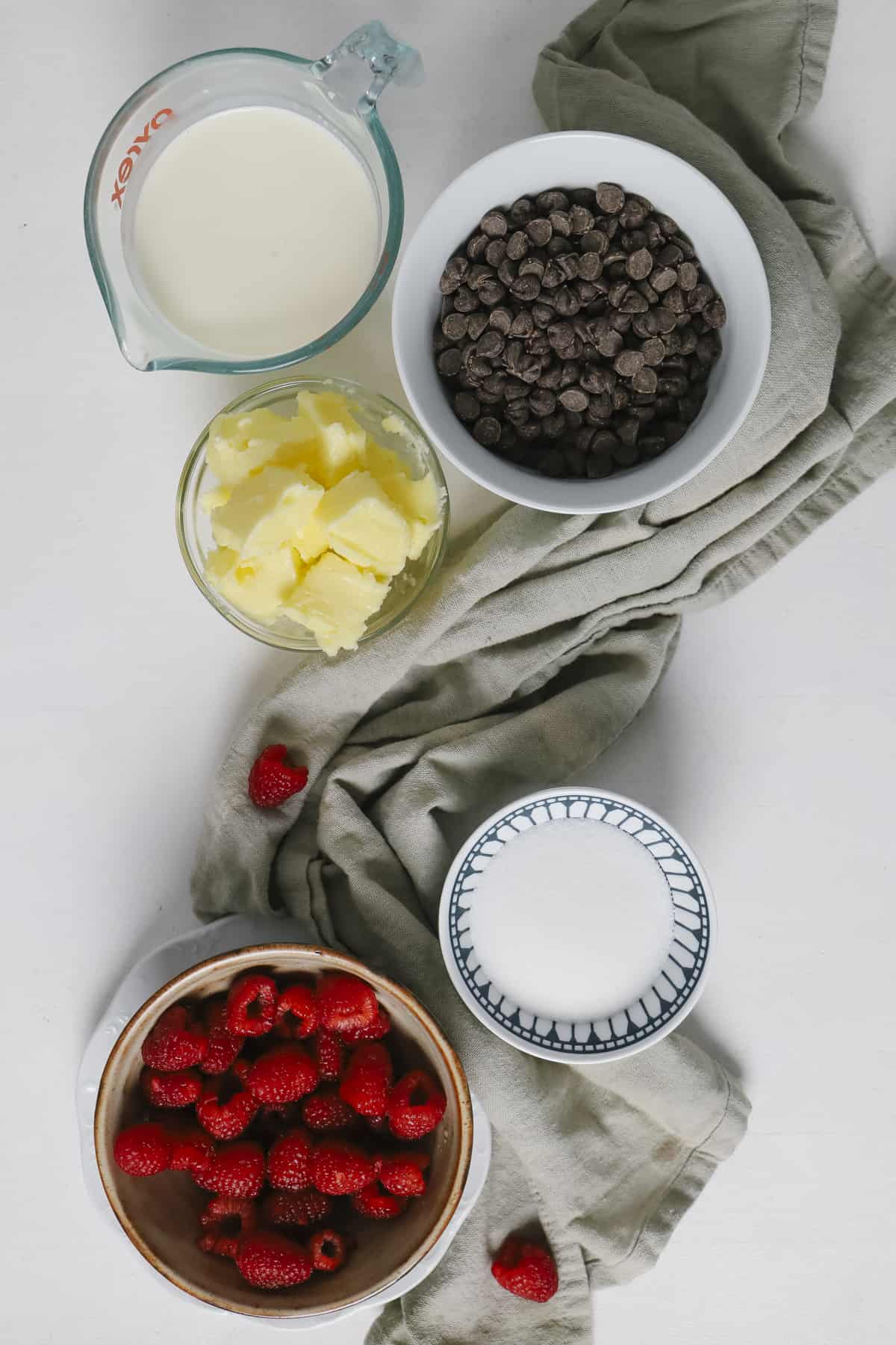 Top view of ingredients in small ramekins with a grey towel