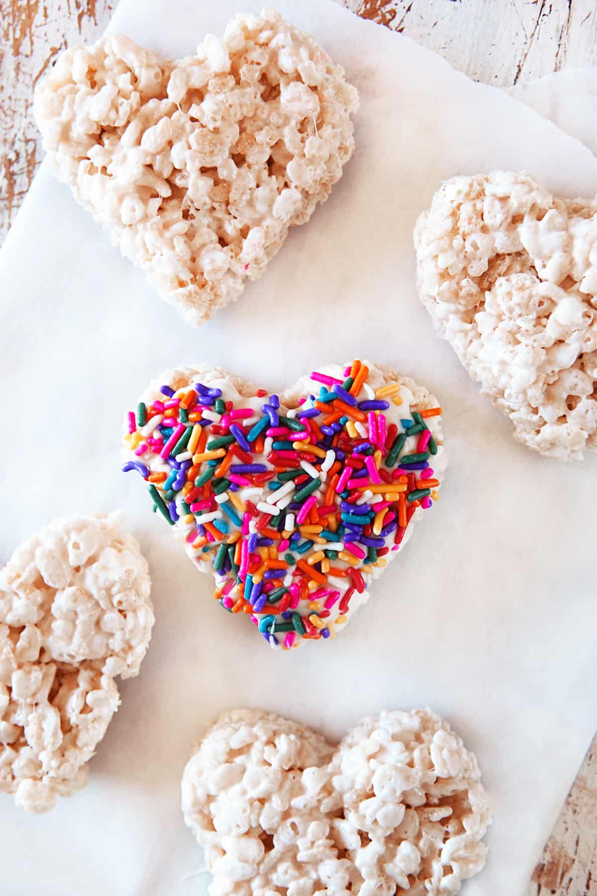 Colorful sprinkles on a heart shaped rice Krispie. 