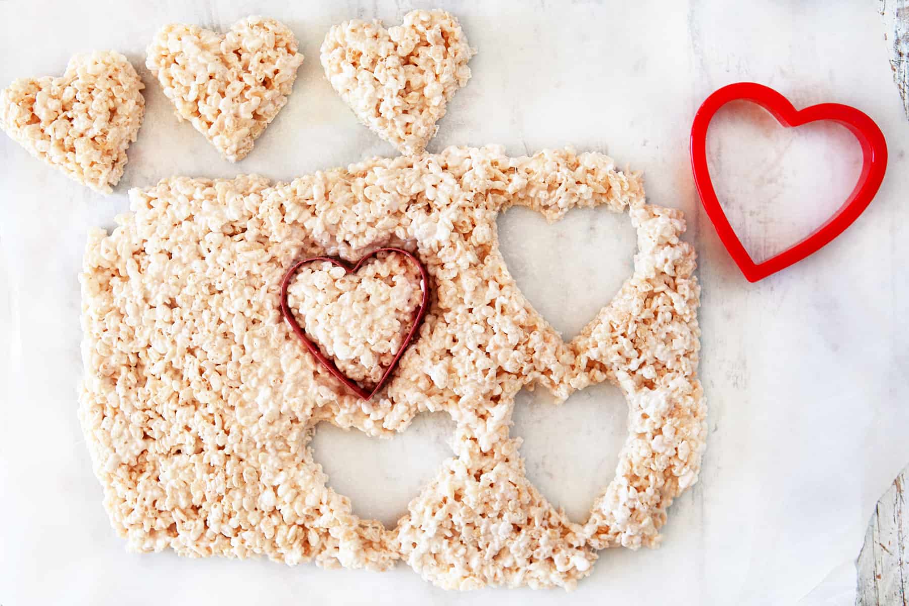 Cutting out heart shapes from rice krispie treats. 