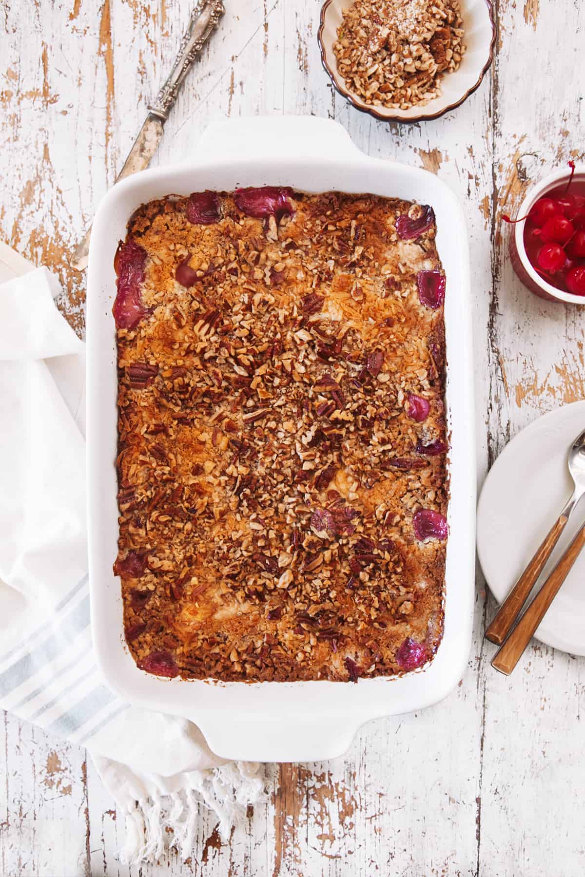 Overhead shot of Cherry Pineapple Dump Cake  in a white casserole. 