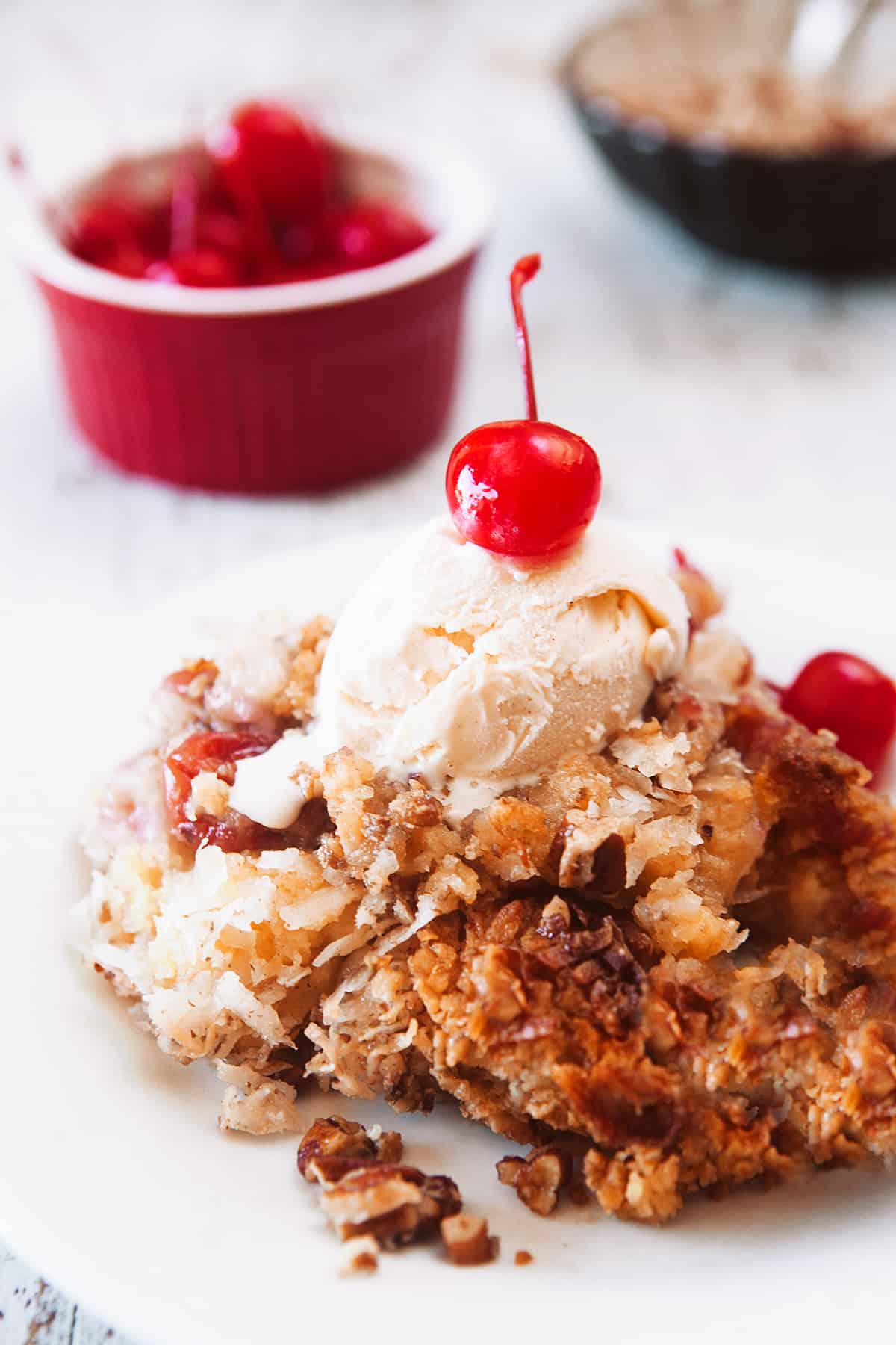 Cherry Pineapple Dump Cake with ice cream and a cherry on top!