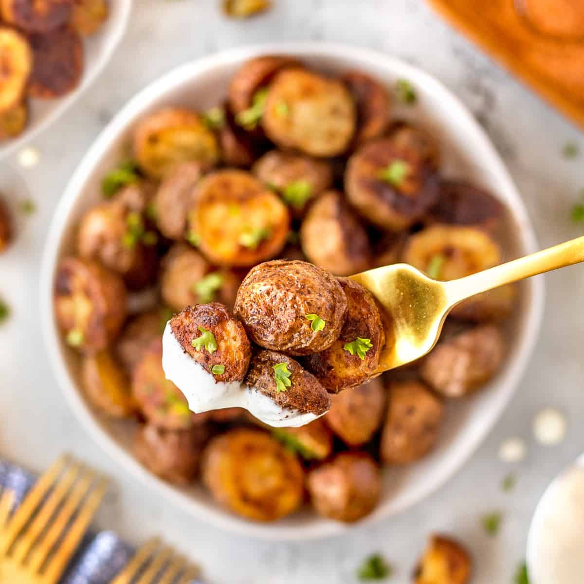 Overhead shot of potatoes on a fork dipped in dressing