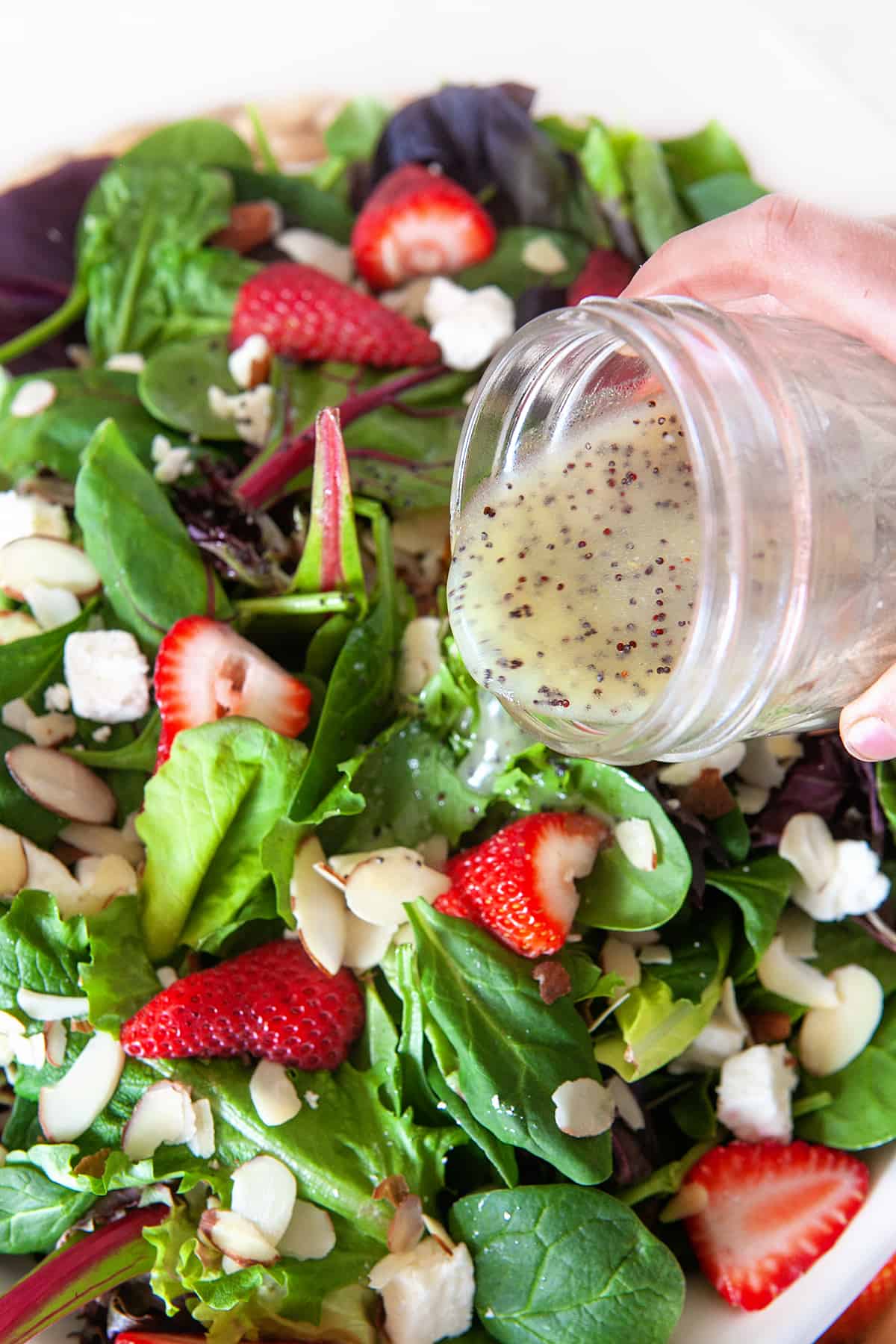 Pouring Poppy Seed Dressing on a salad