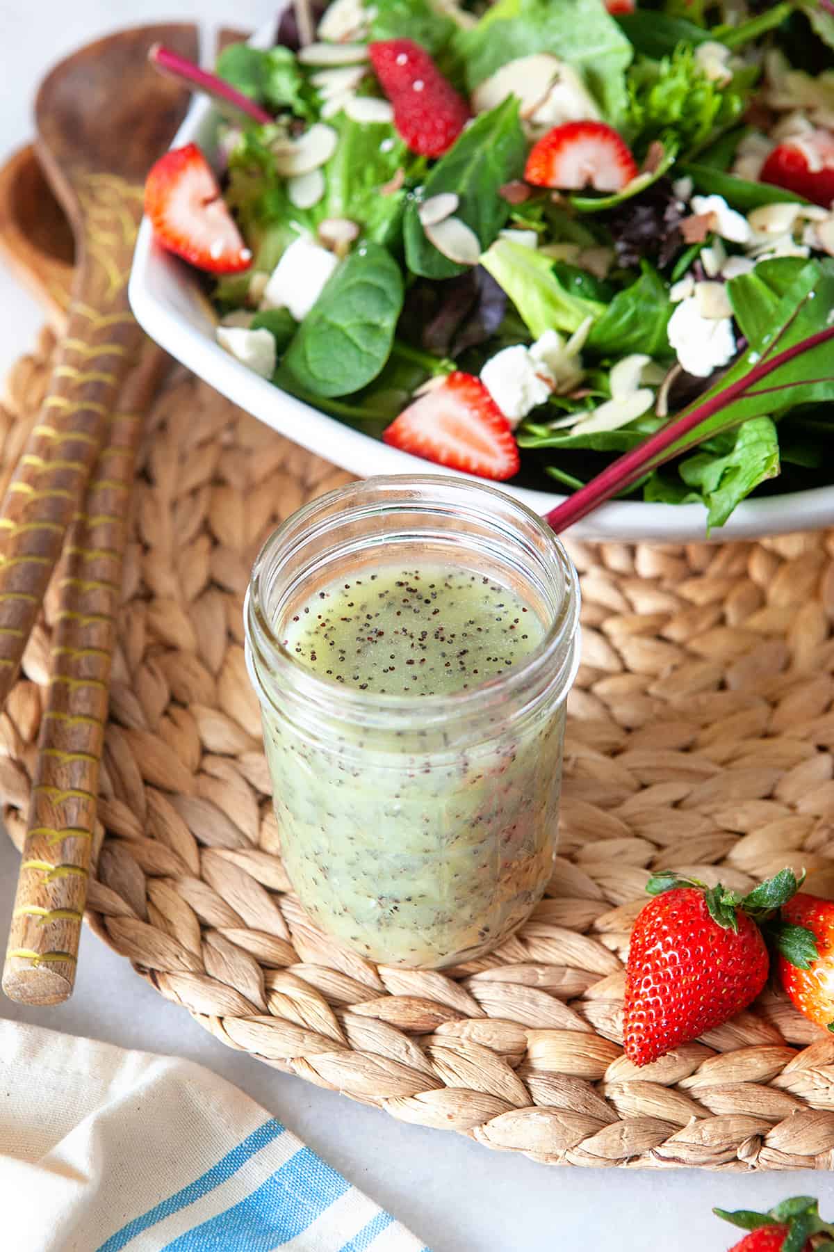 Poppy Seed Dressing on a woven mat with a strawberry salad