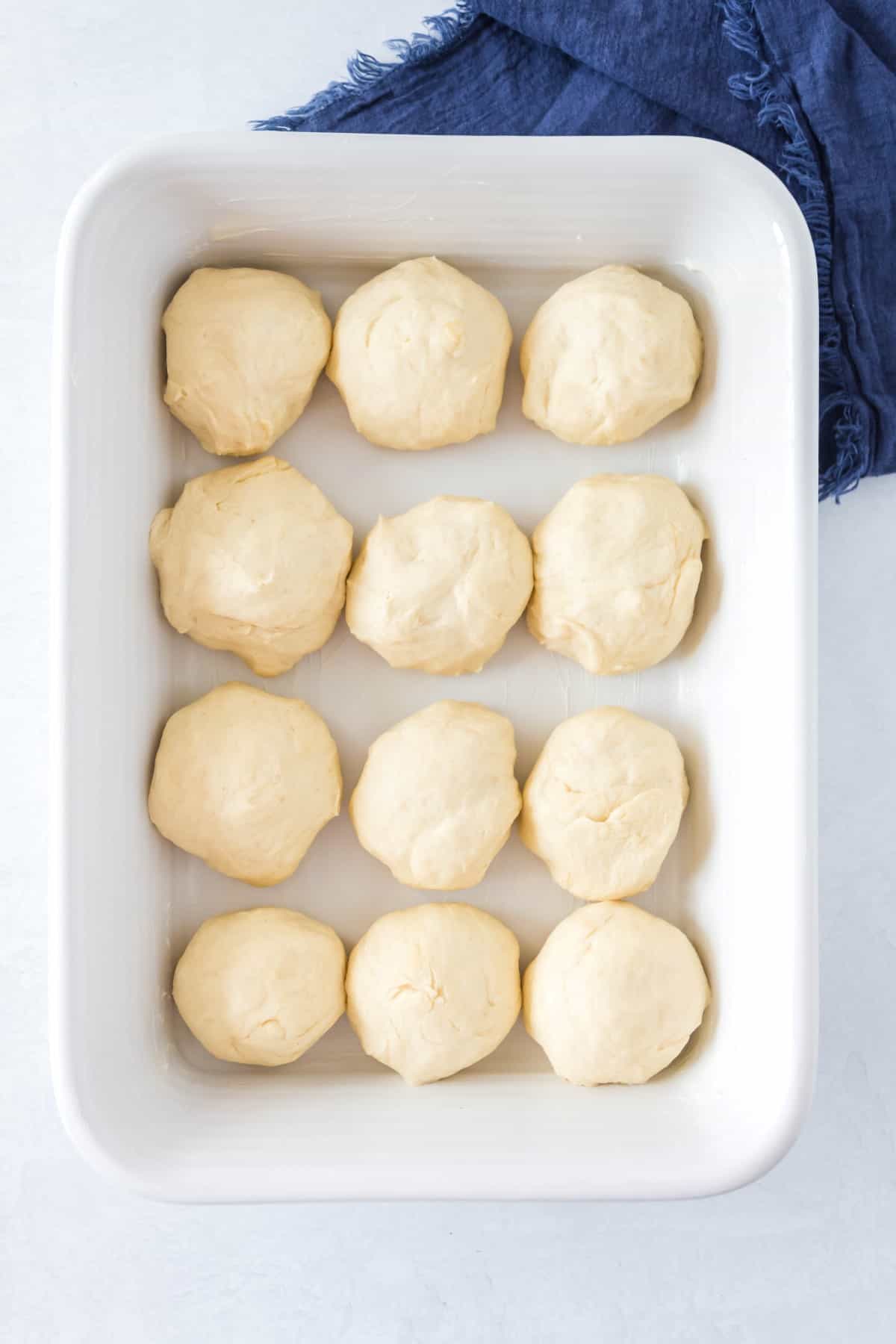 Rolls not proofed yet in a baking pan. 