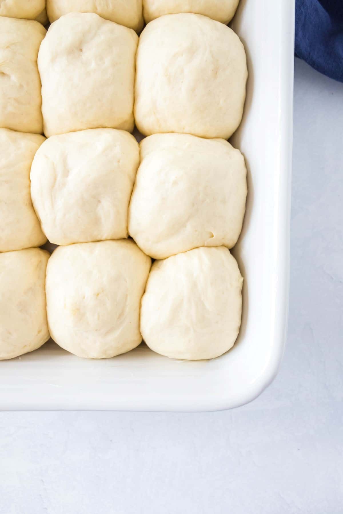 Unbaked rolls in a baking pan. 