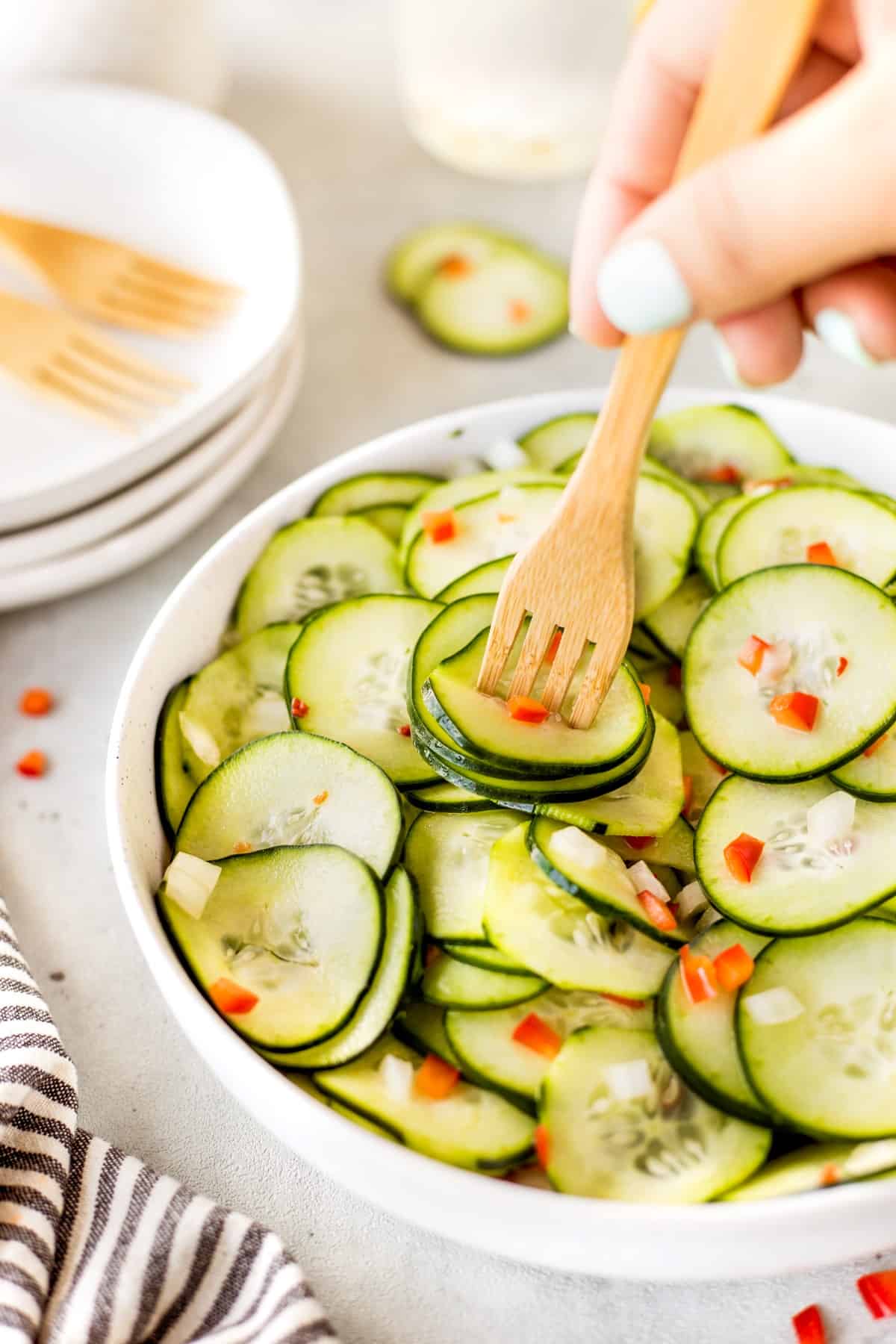 Sticking a wooden fork into cucumber salad