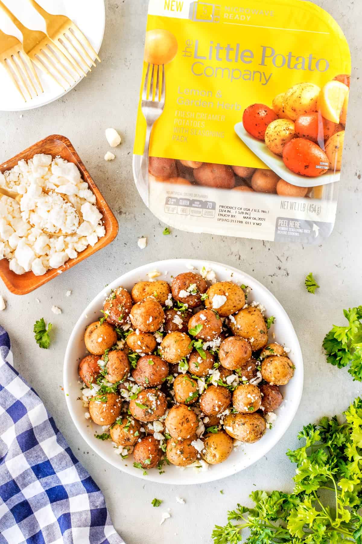 Overhead picture of potatoes in a bowl with Little Potato Company packaging. 