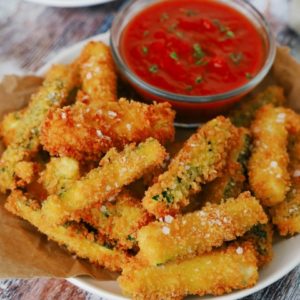 Plate of fried zucchini with tomato dipping sauce