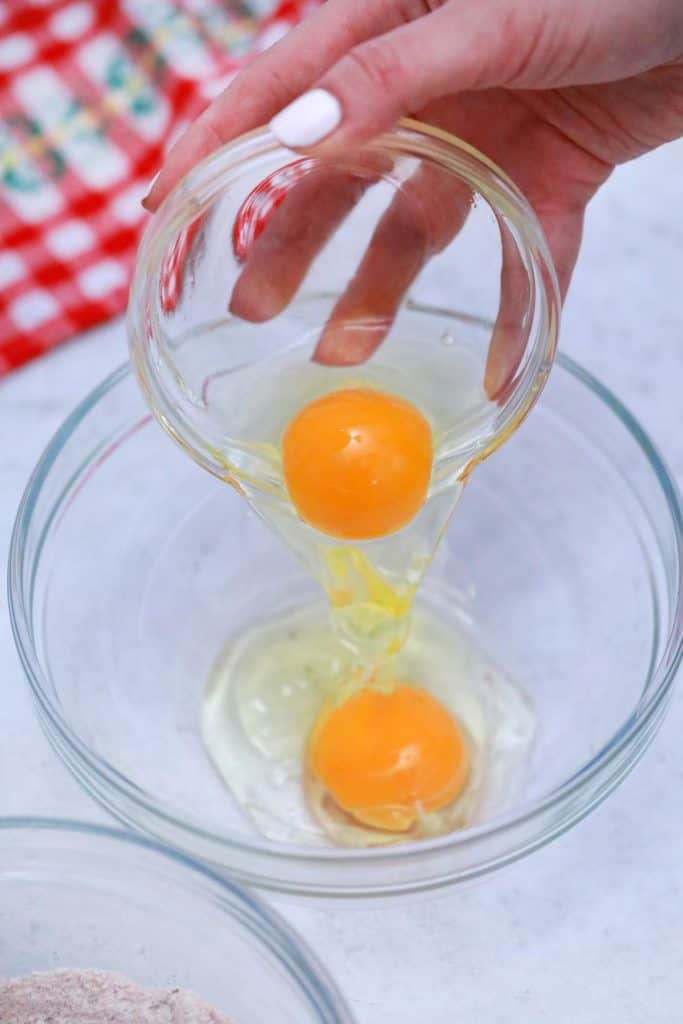 Eggs being poured into a bowl