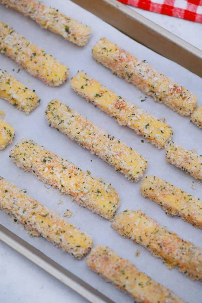 Cheese sticks before frying on a baking sheet