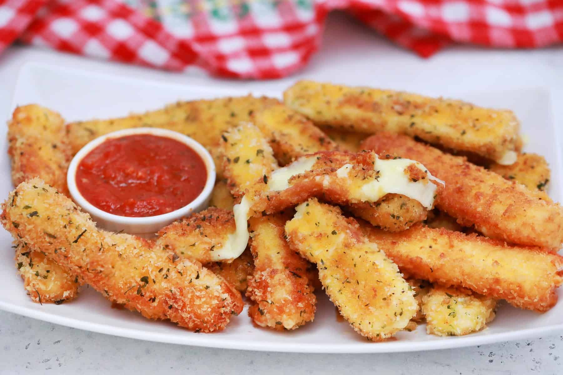 Horizontal picture of a platter of cheese sticks. 