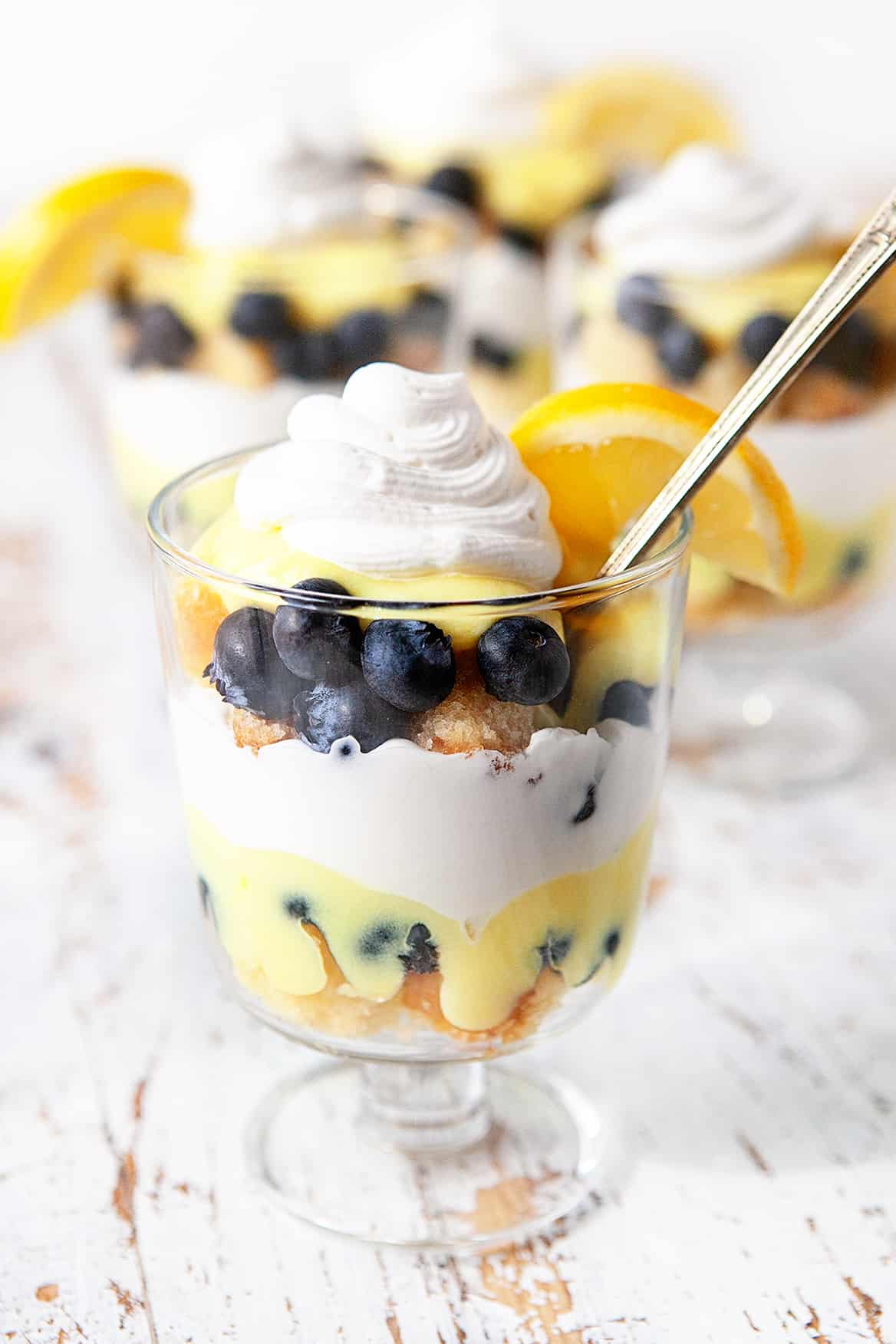 Lemon Blueberry Trifle, individual servings with a spoon. 