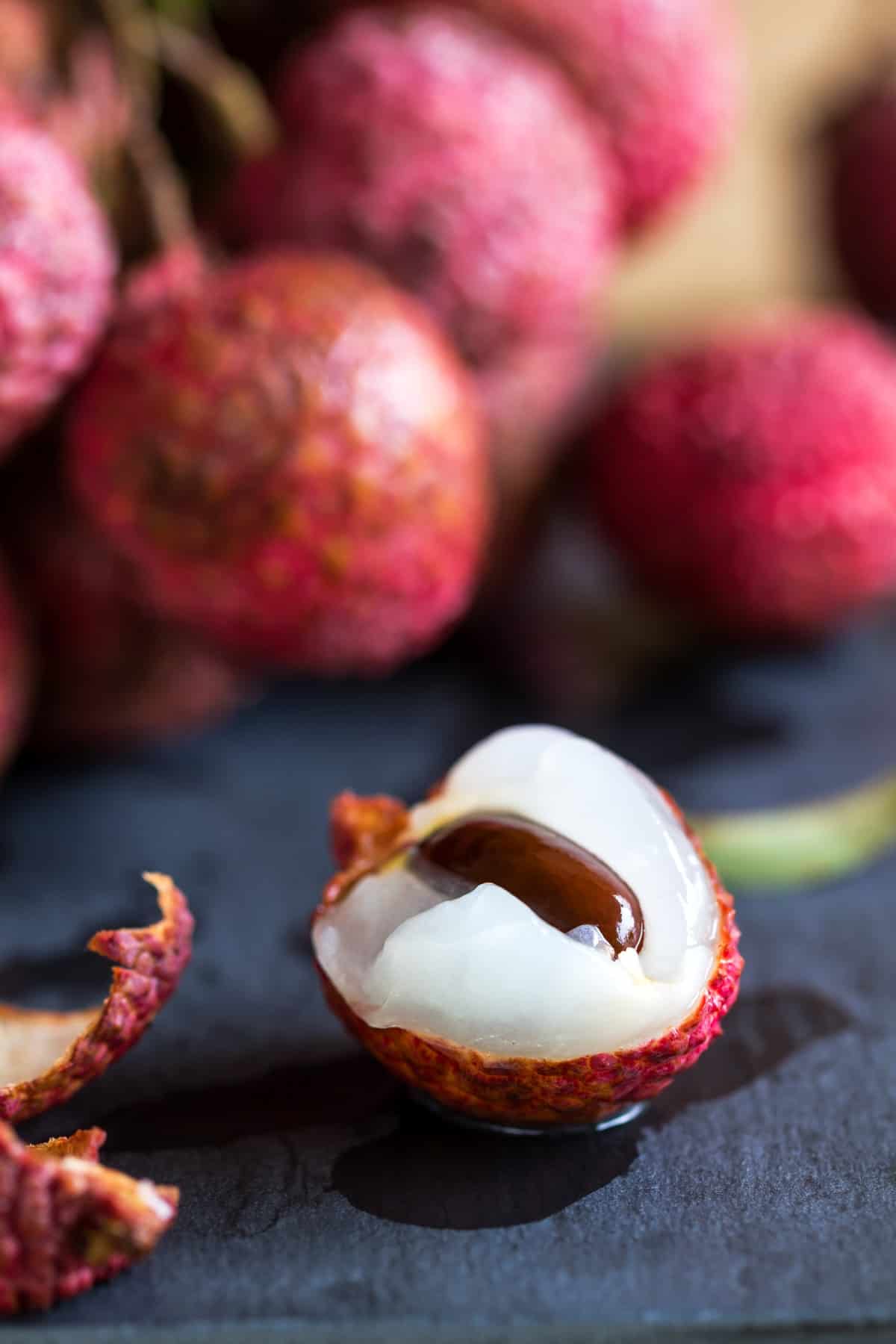 Fresh bunch of Lychees on wooden table