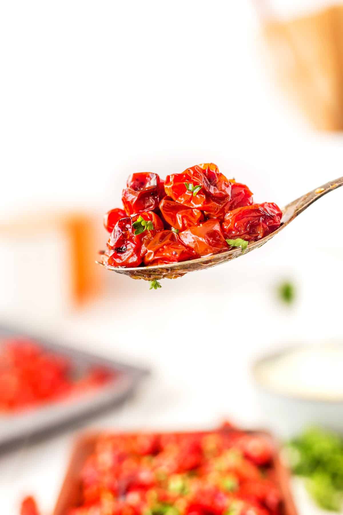 Side view of a spoonful of roasted grape tomatoes