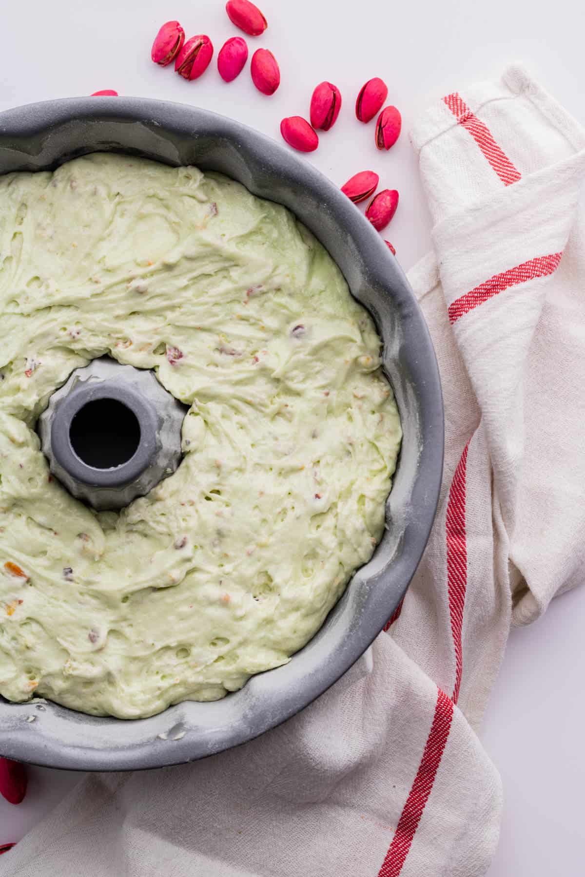 A bundt cake pan filled with green batter. 