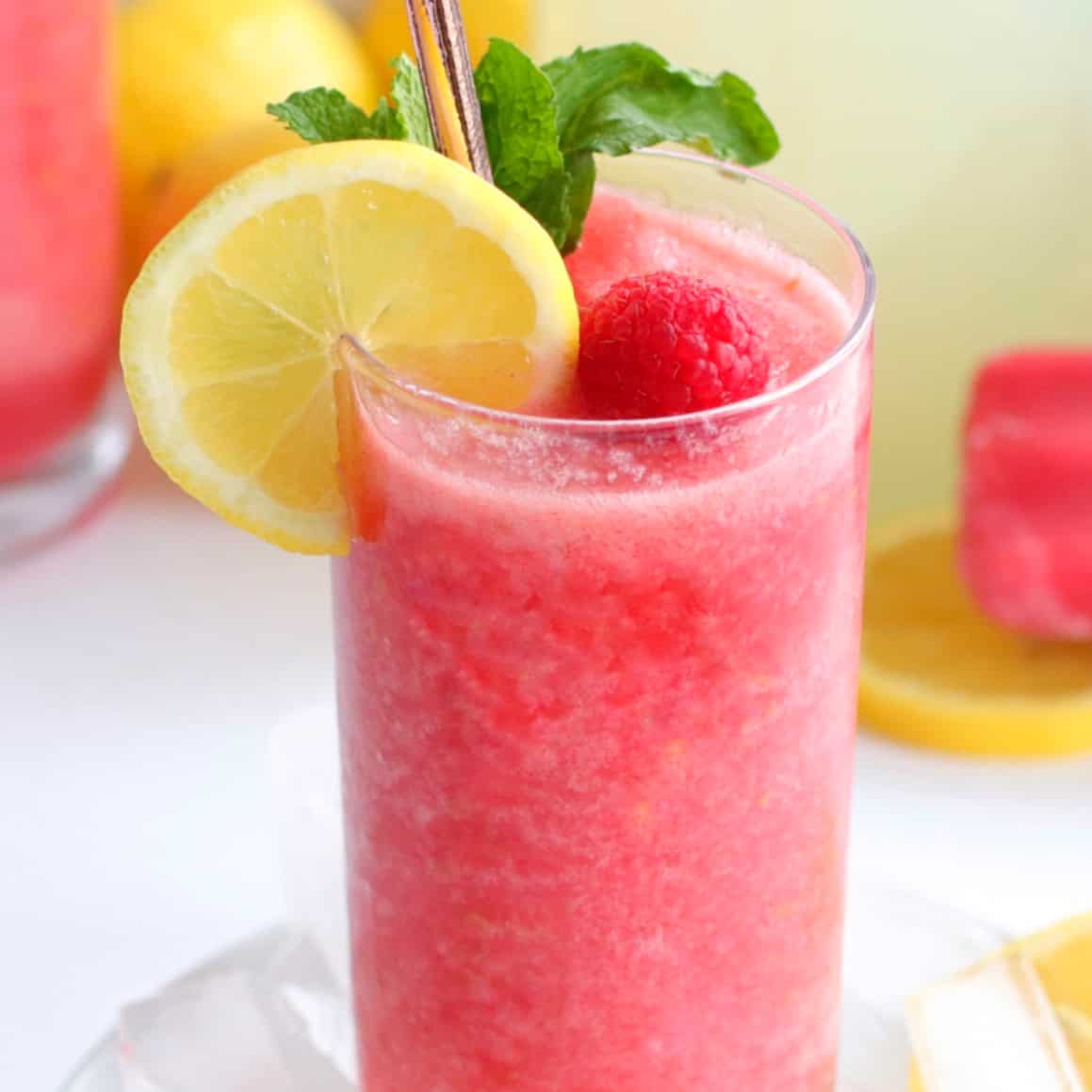 Closeup glass of Chambord Frozen Lemonade with lemon, raspberry and mint as a garnish