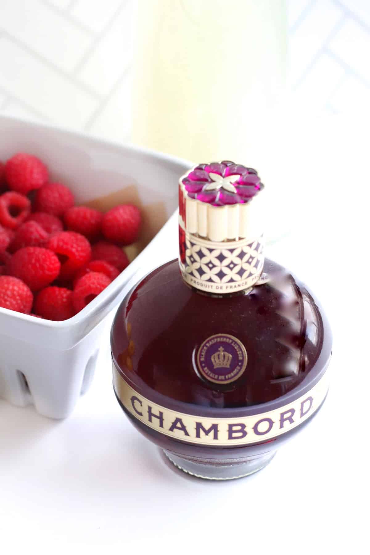 A bottle of Chambord with raspberries
