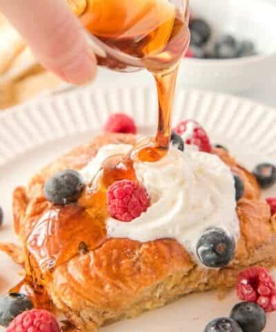 Pouring maple syrup on French toast