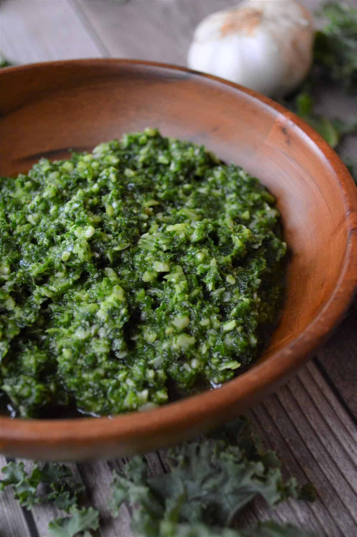 Deliciously Easy Kale Pesto Recipe in a wooden bowl. 