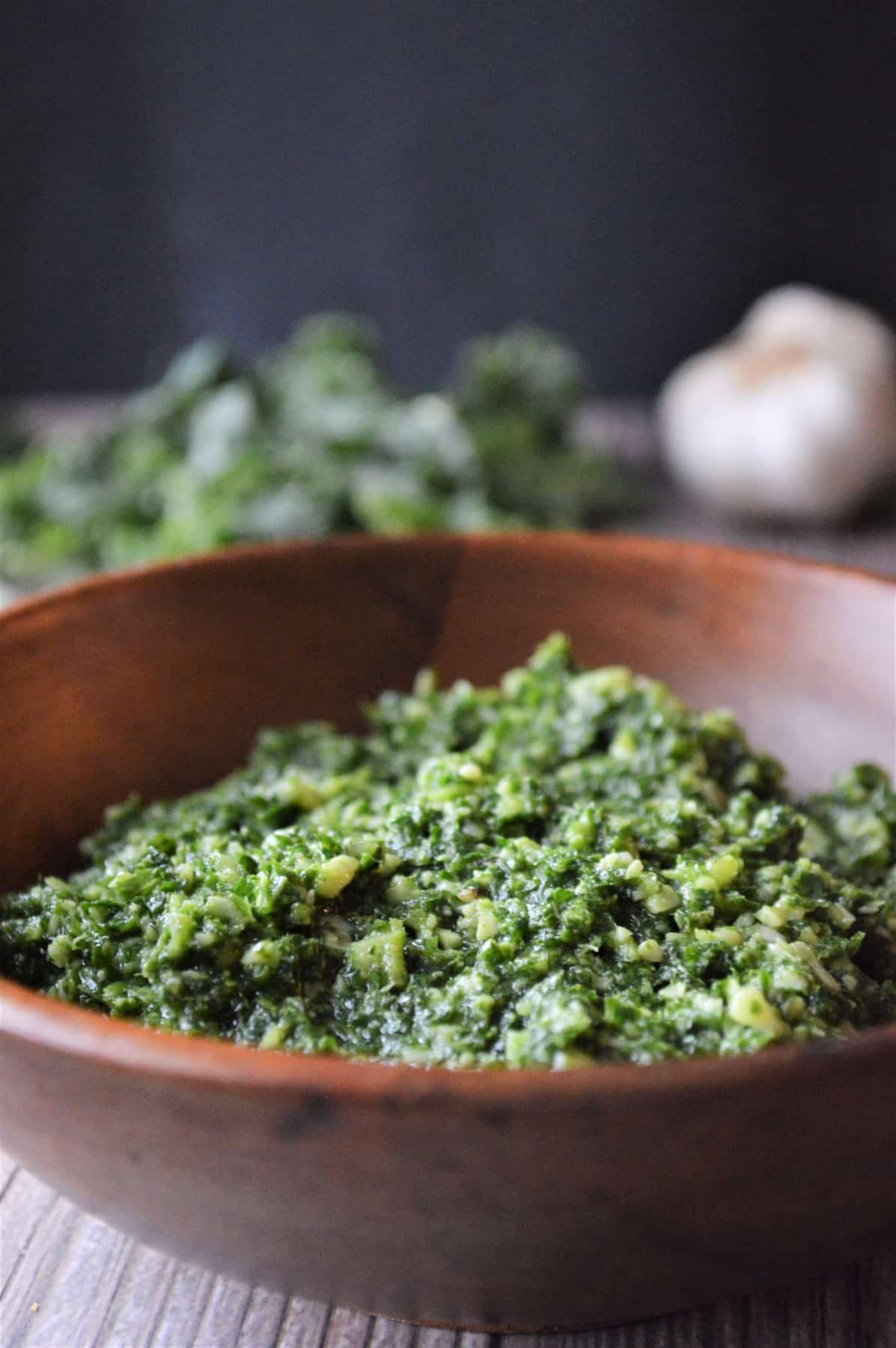 Deliciously Easy Kale Pesto Recipe in a wooden bowl. 