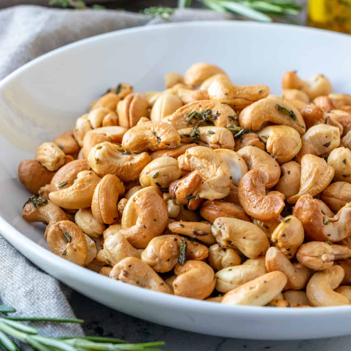 Closeup square shot of golden brown roasted cashews. 