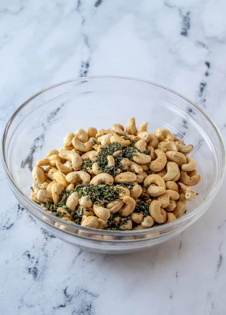Cashews in a bowl with herbs