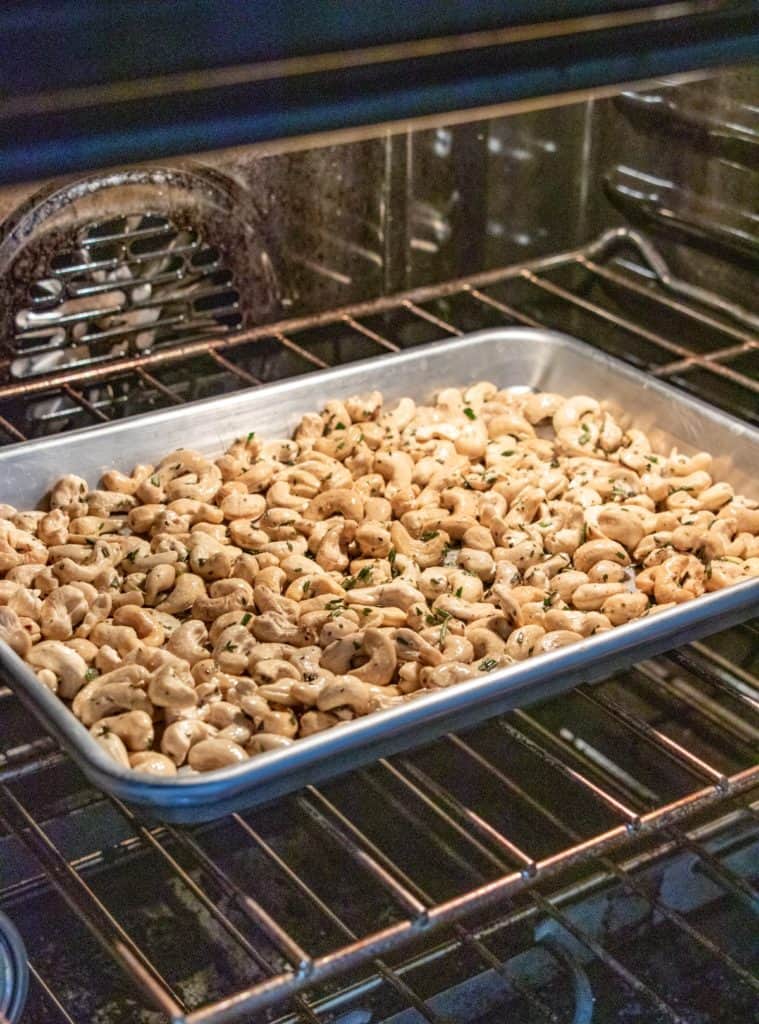 Cashews on a baking sheet in an oven