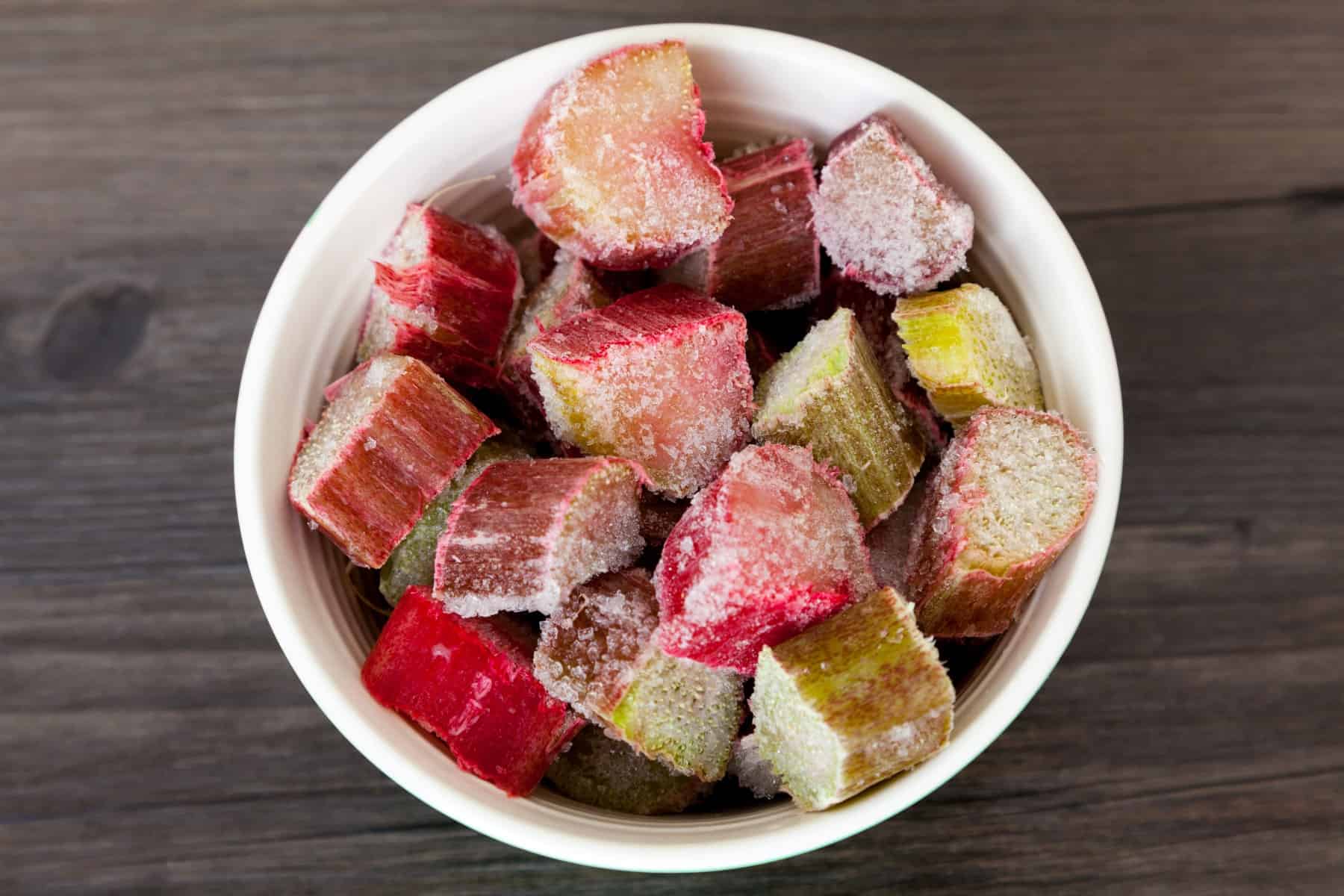 Frozen chunks of rhubarb in a bowl - top down view