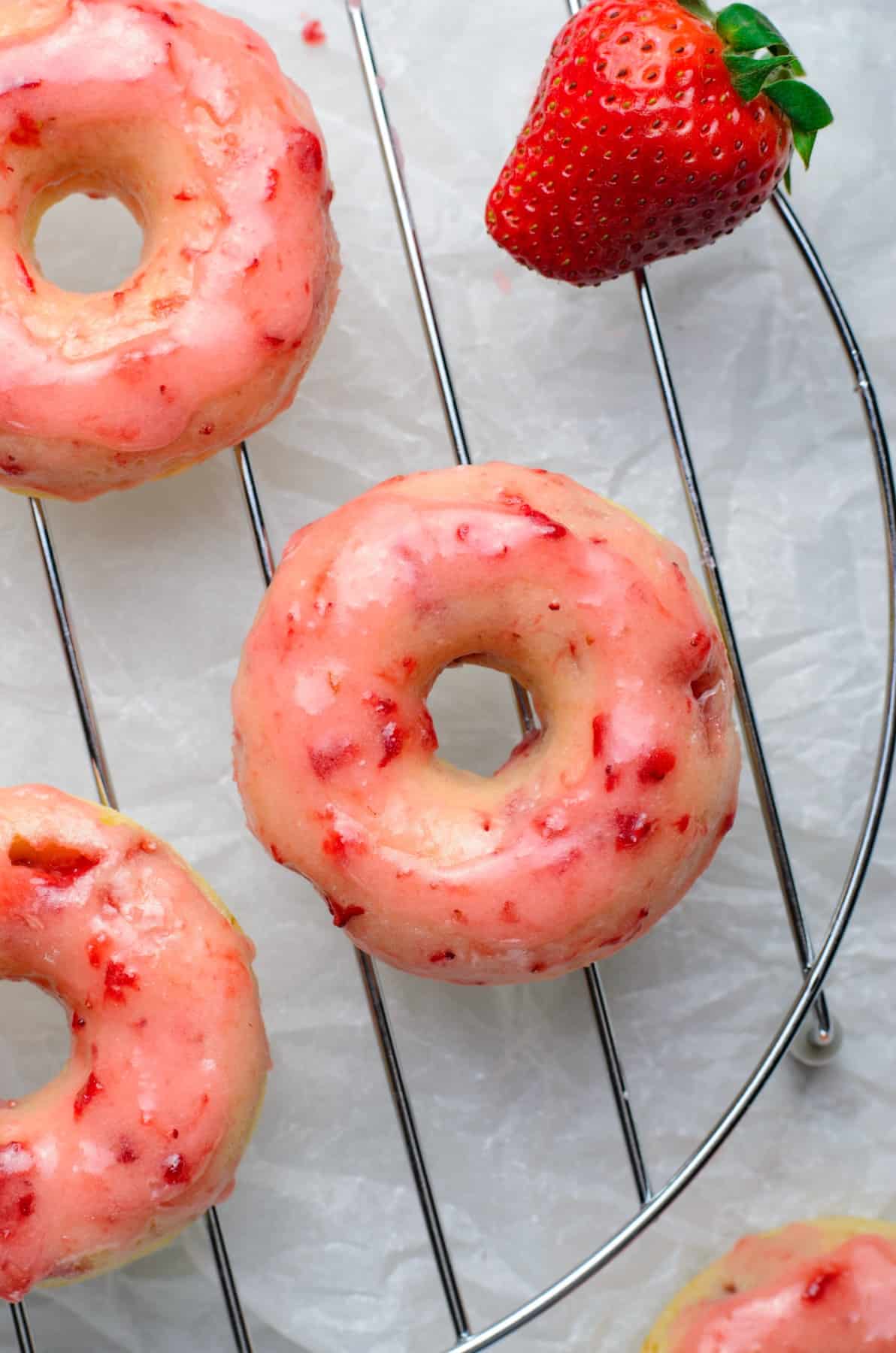 Overhead vertical shot of glazed Baked Strawberry Donuts
