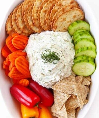 Boursin Cheese Recipe in a oval bowl with crackers and veggies.