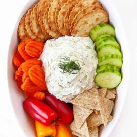 Boursin Cheese Recipe in a oval bowl with crackers and veggies.