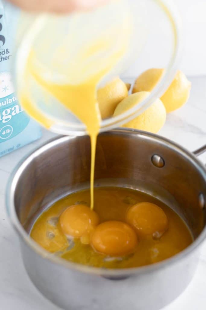 Pouring egg yolks into a pot