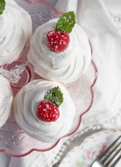 Overhead shot of pavlovas on a pink stand.