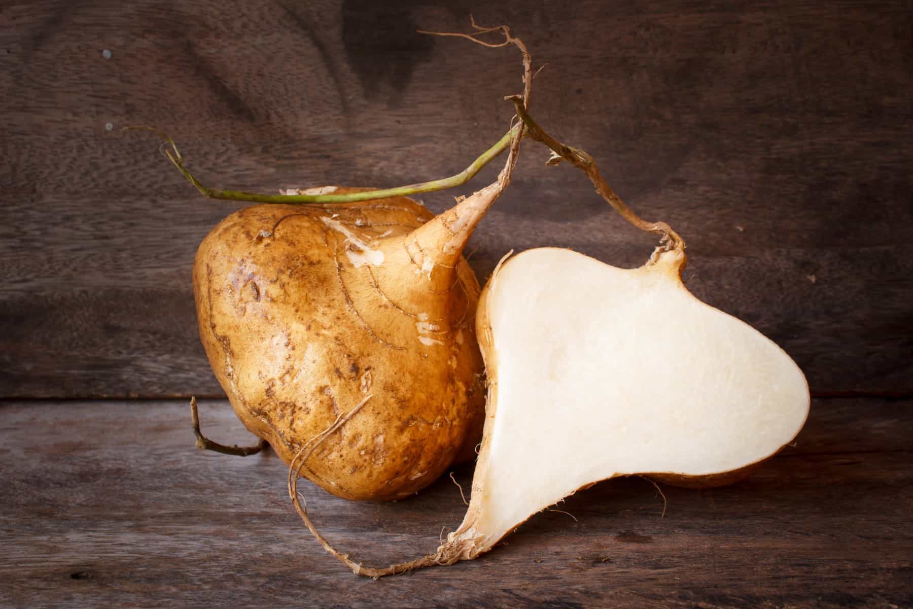 jicama or yam-bean on old wood background, still life.