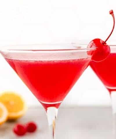 Lemon Cherry Martini with lemons and cherries in the background