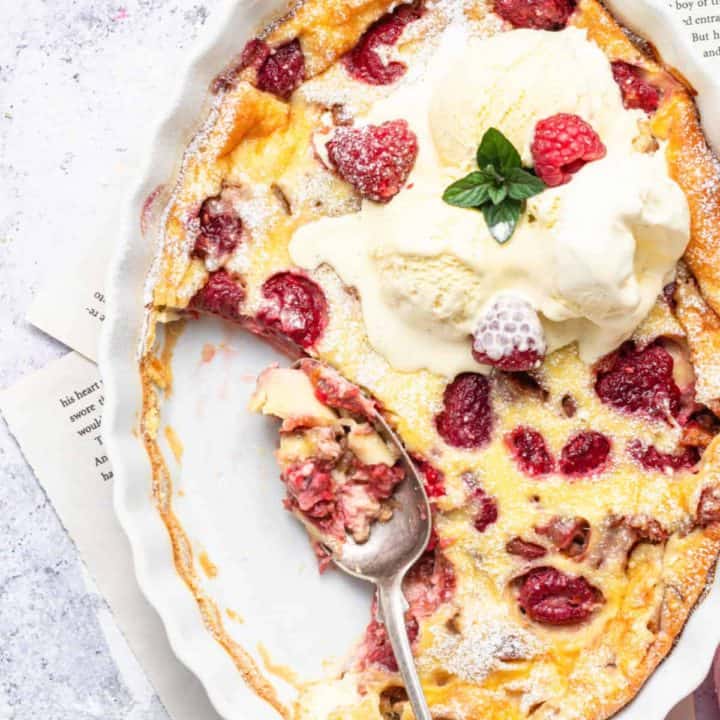 Rhubarb Raspberry Clafoutis with vanilla ice cream with some scooped out of dish