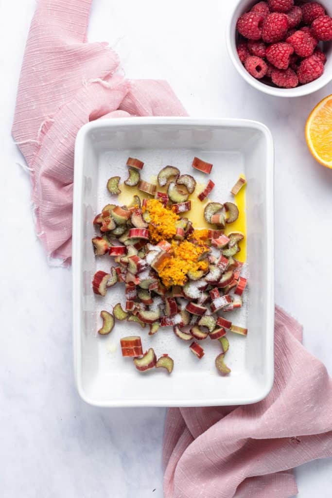 Rhubarb, orange zest and sugar in a baking dish