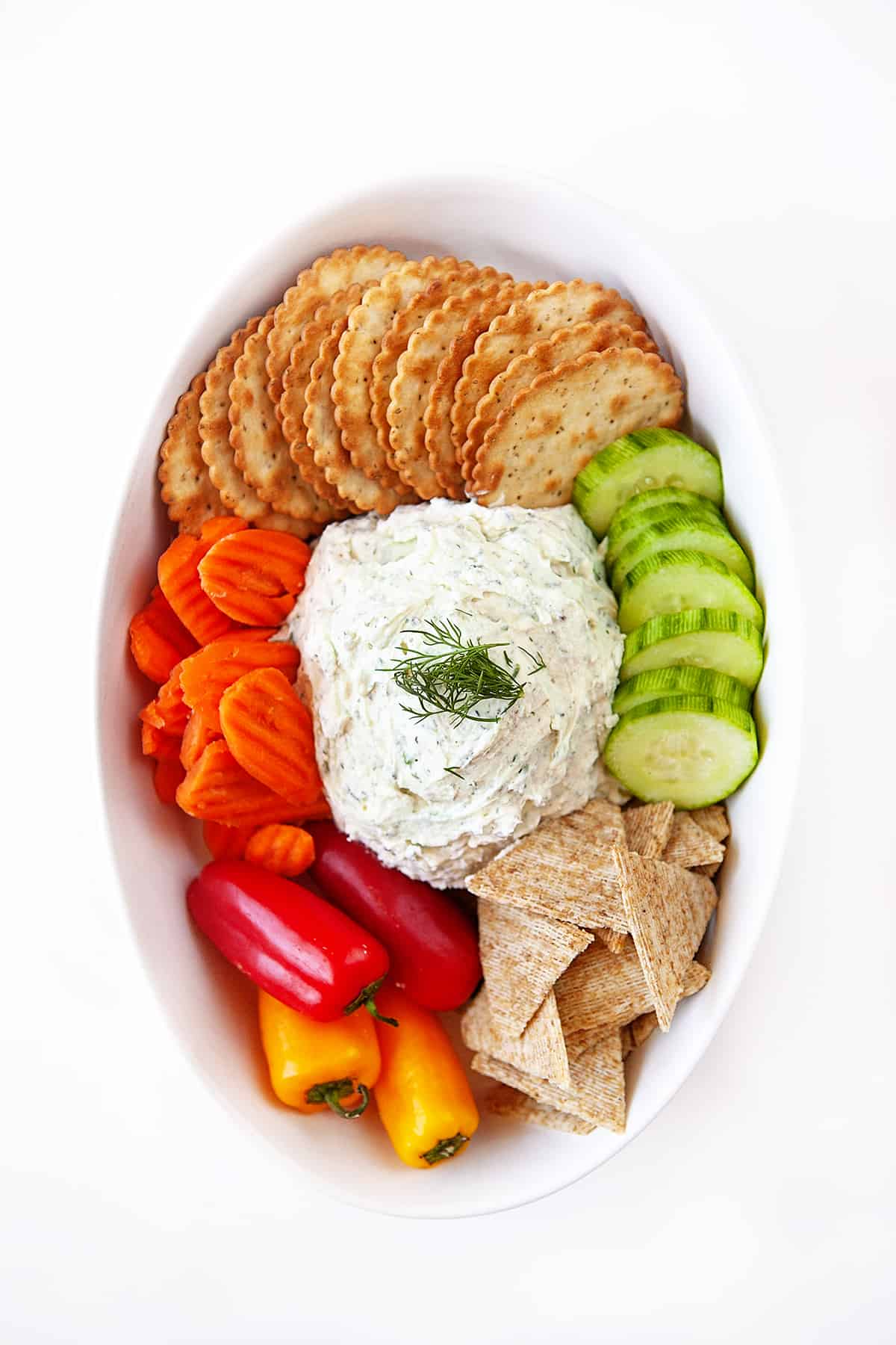 Boursin Cheese Recipe overhead shot in an oval bowl with crackers and veggies