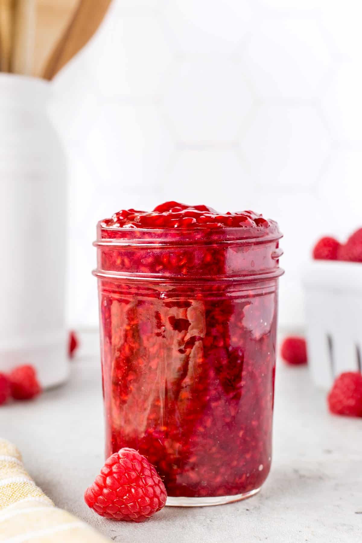 A very full jar of raspberry sauce