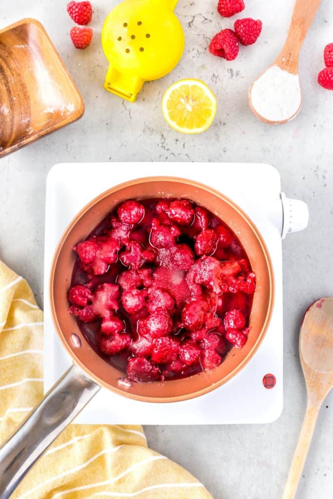 Raspberries and ingredients in a pot
