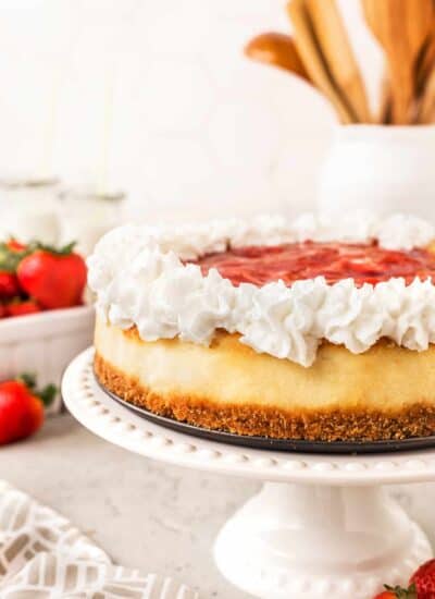 Light and Airy Strawberry Cheesecake on a cake stand.
