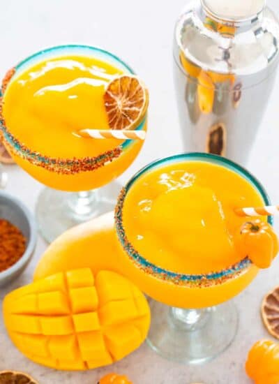 Mango Habanero Margaritas in glasses, shaker and fresh mango.