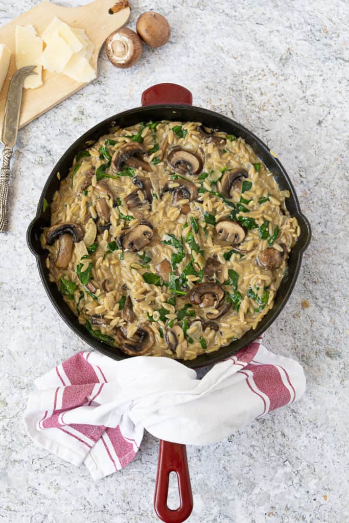 finished pan of Creamy Mushroom Orzo with spinach