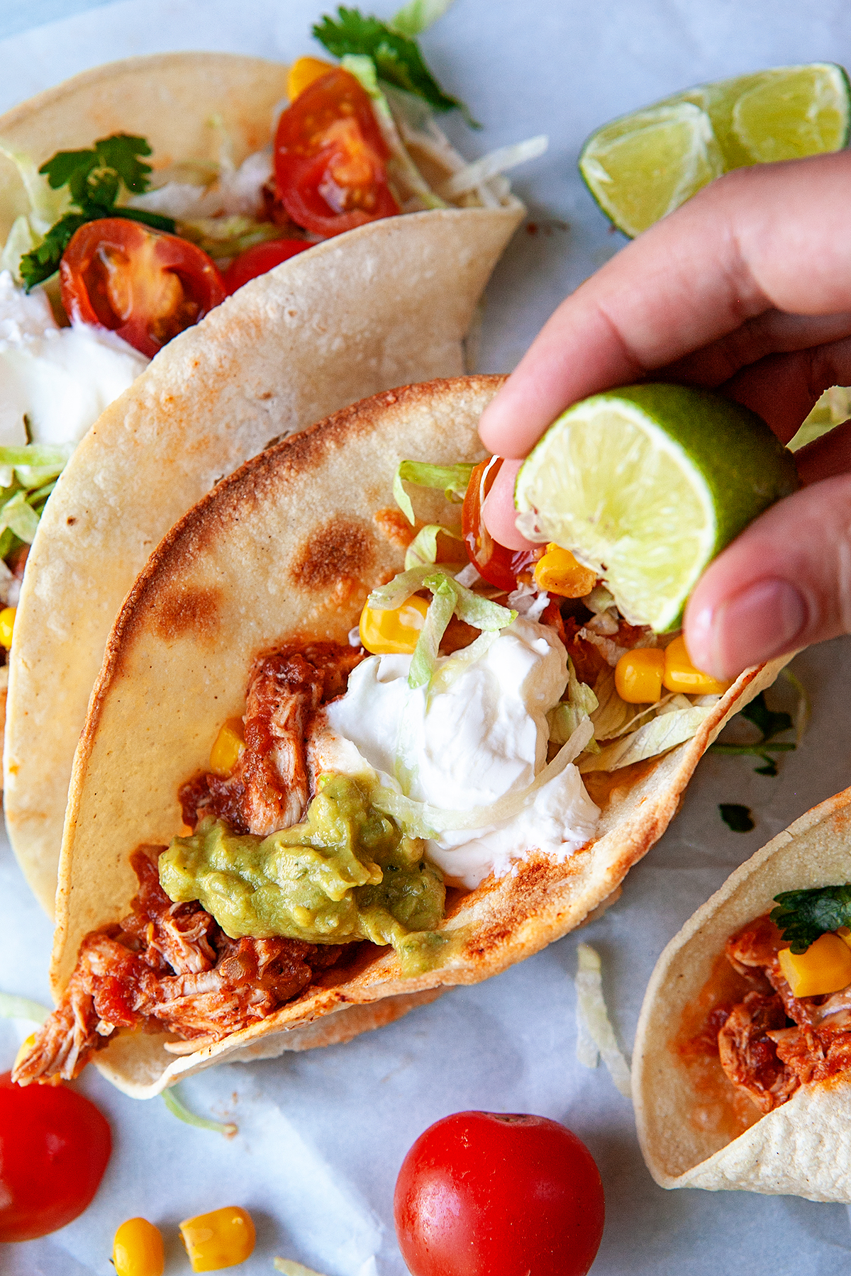 Squeezing lime on Easy Fast Rotisserie Chicken Tacos