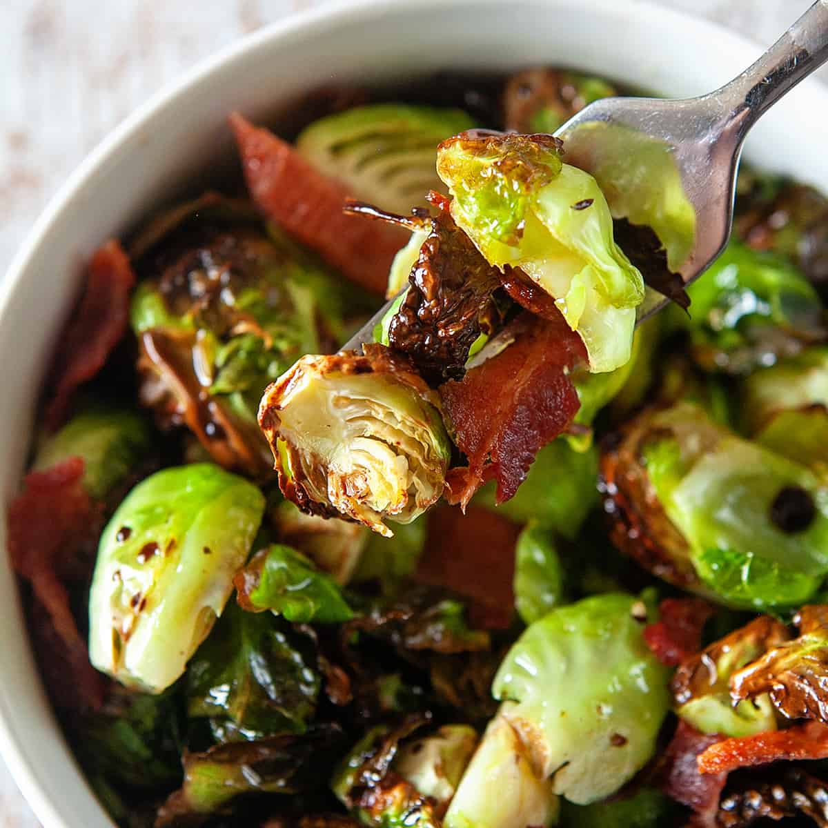 Forkful of air fryer Brussels sprouts with bacon. 