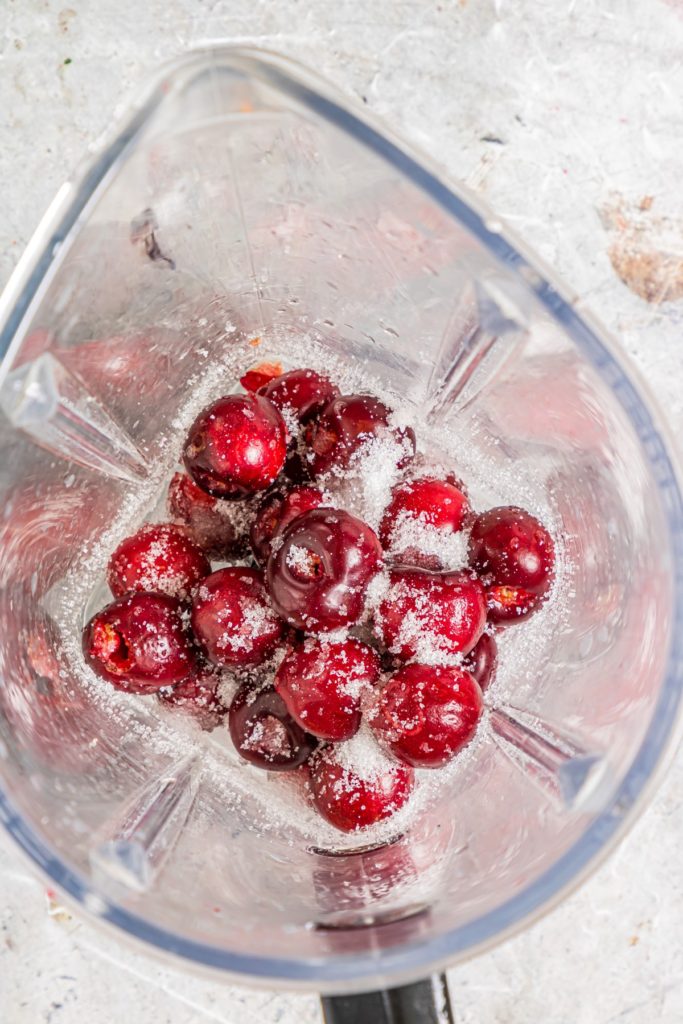 Cherries and sugar in a blender
