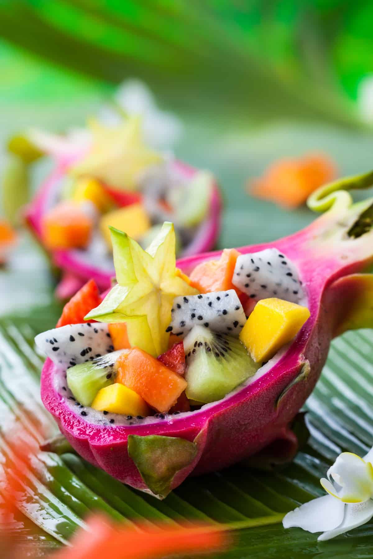 Exotic fruit salad served in half a dragon fruit