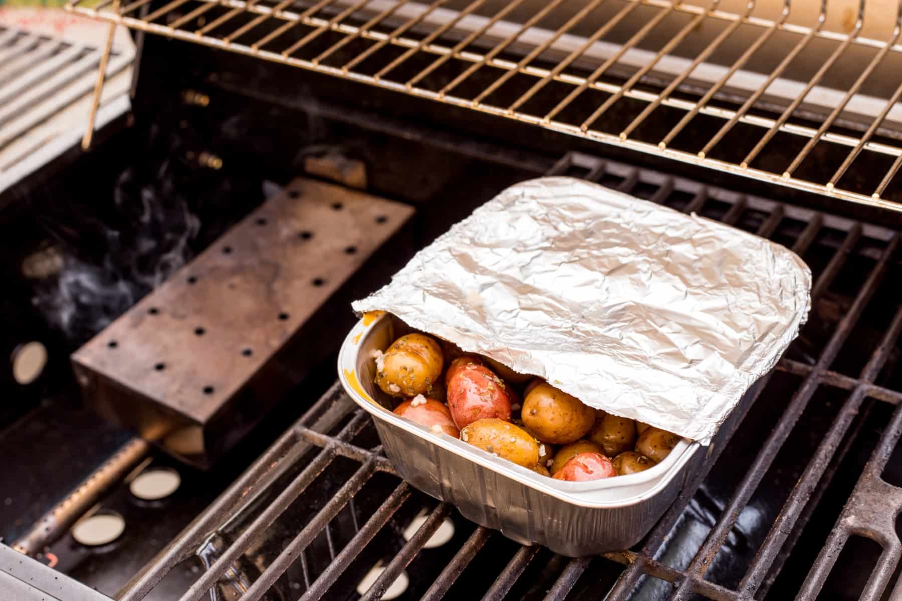 Potatoes in a pan on the BBQ