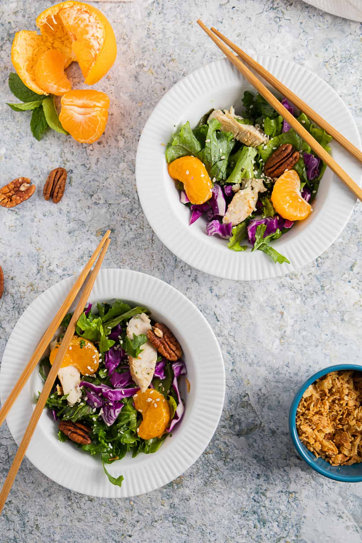 Overhead shot of two mandarin chicken salads in bowls. 